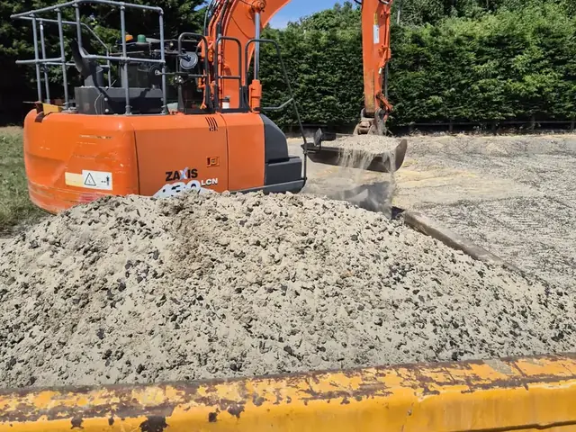 Excavator digging a service trench on a Malling Utilities site