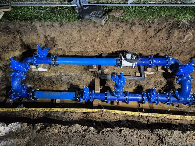 Blue valve assembly on a new water main in an open trench