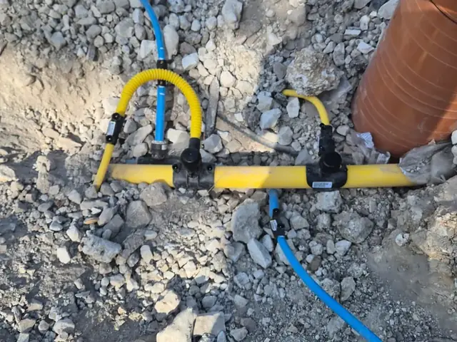 Water and gas service pipes to a meter box