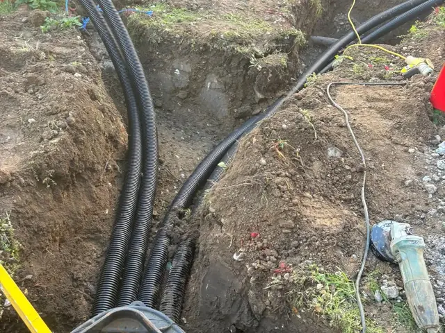 Multiple cable ducts run into a jointing chamber at a Burger King drive-thru