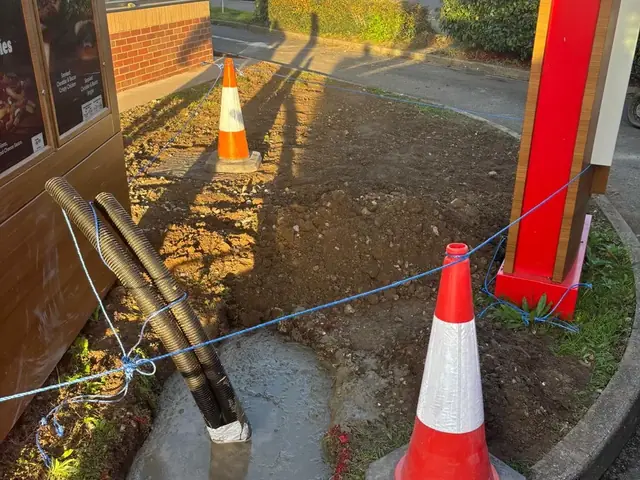 Cable ducting and service cables run in at a Burger King drive-thru in Kent