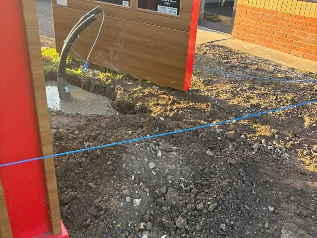 Cable ducting rising to the order point at a Burger King drive-thru in Kent