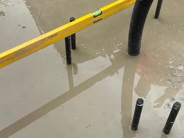 Holding-down bolts checked for level on a new Burger King sign footing