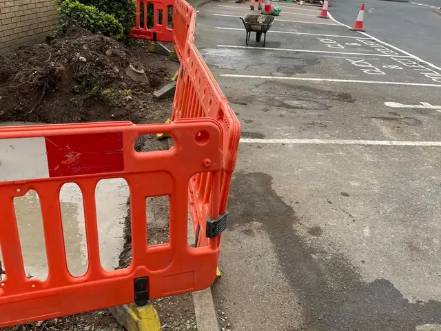 Barriered works in a retail-park bay for a new Burger King sign base, Kent
