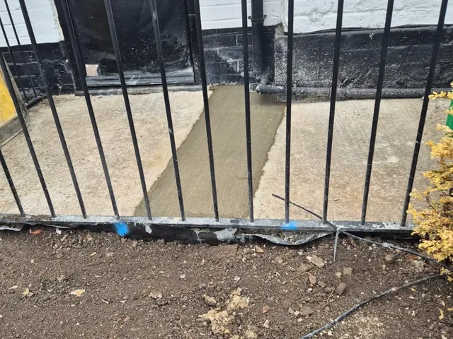 New concrete path reinstated at the pub entrance after the supply pipe works