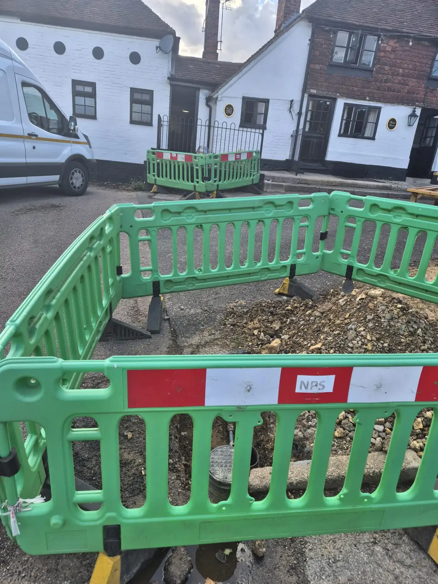 Excavation fenced off outside the pub in West Malling with the old supply exposed Excavation fenced off outside the pub in West Malling with the old supply exposed