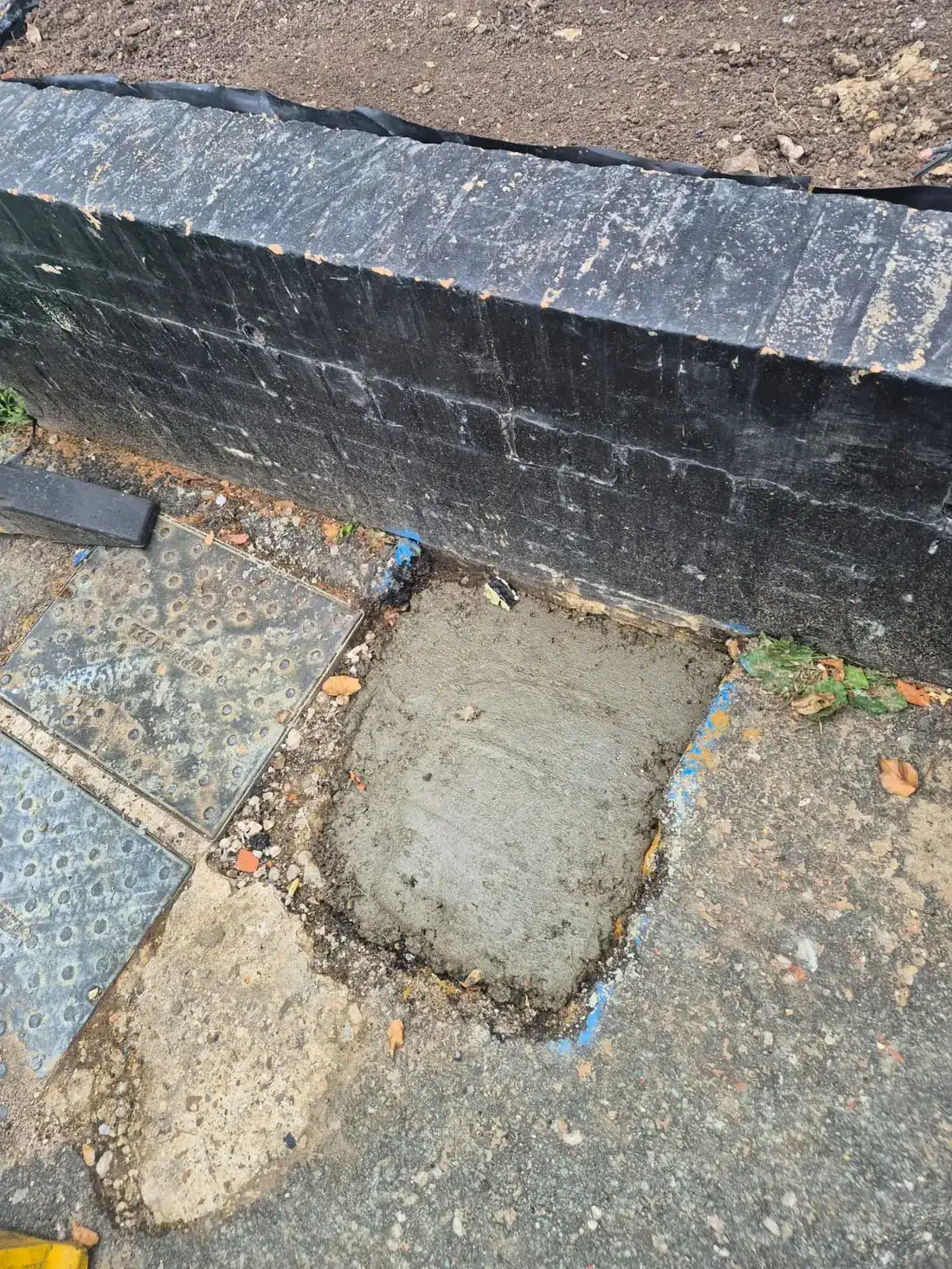 Concrete reinstated over the completed excavation beside the pub wall Concrete reinstated over the completed excavation beside the pub wall
