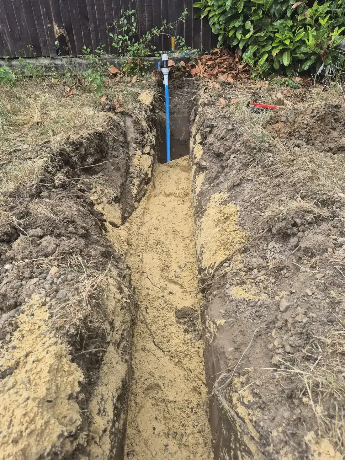 The sand-covered supply run brought up at the boundary, ready for South East Water to connect The sand-covered supply run brought up at the boundary, ready for South East Water to connect