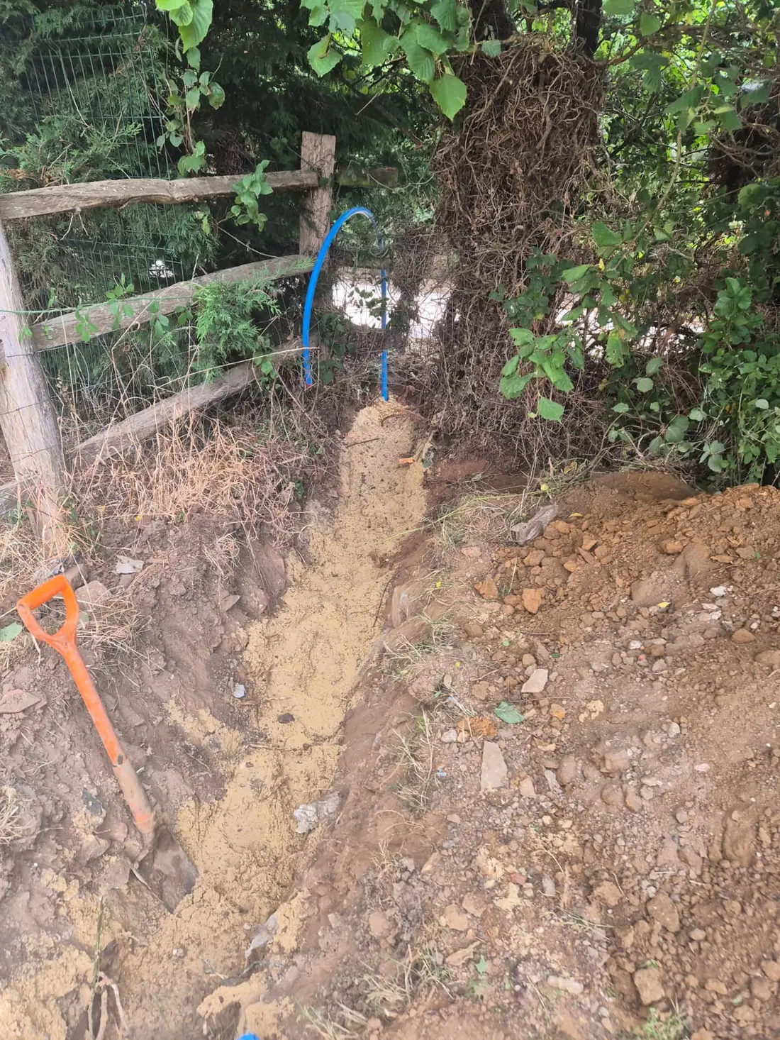 Excavating the new supply trench alongside the paddock fence in Sevenoaks Excavating the new supply trench alongside the paddock fence in Sevenoaks