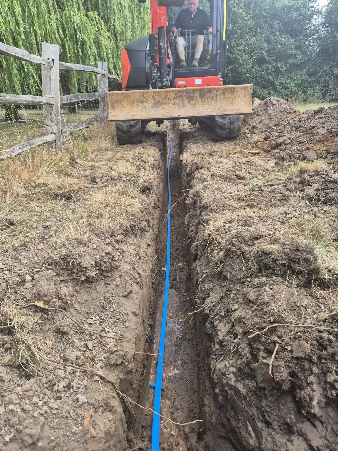 The new blue supply pipe laid in the open trench in Sevenoaks The new blue supply pipe laid in the open trench in Sevenoaks